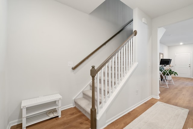 staircase with wood-type flooring