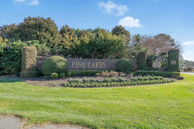 community / neighborhood sign with a lawn