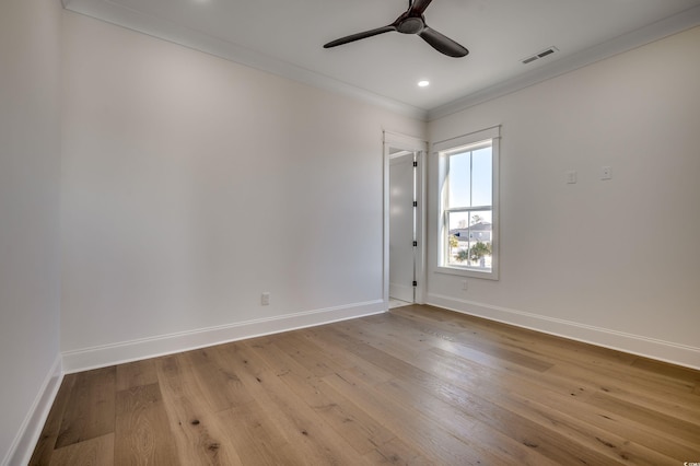 empty room with ceiling fan, ornamental molding, and light hardwood / wood-style floors