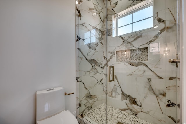 bathroom with toilet and an enclosed shower