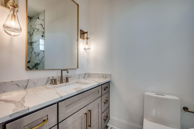 bathroom featuring toilet, vanity, and tiled shower