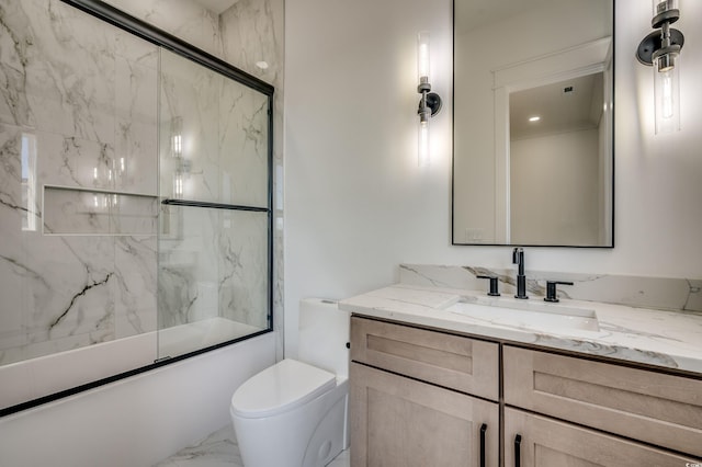 full bathroom with combined bath / shower with glass door, vanity, and toilet