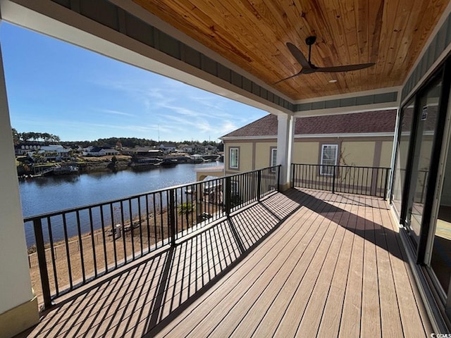 wooden terrace featuring ceiling fan and a water view