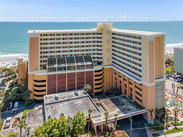 view of property featuring a beach view and a water view