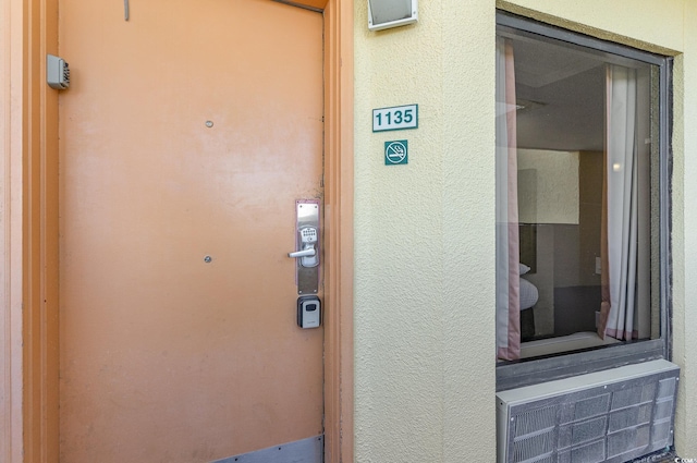 entrance to property with stucco siding