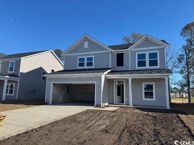 view of front of house featuring a garage and covered porch