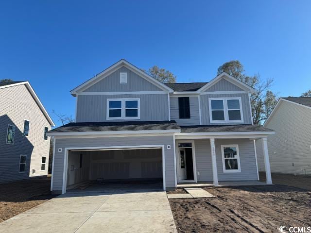 view of front of home with a garage and covered porch