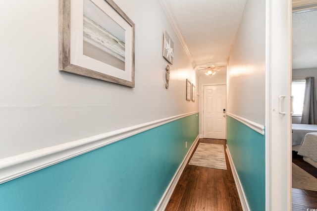 hall featuring ornamental molding and hardwood / wood-style flooring