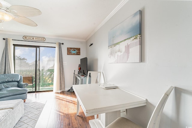 home office featuring light wood-type flooring, ceiling fan, and crown molding