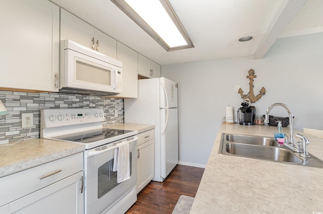 kitchen with white appliances, white cabinetry, dark wood-type flooring, and sink