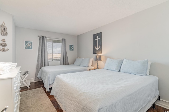 bedroom featuring dark wood-type flooring