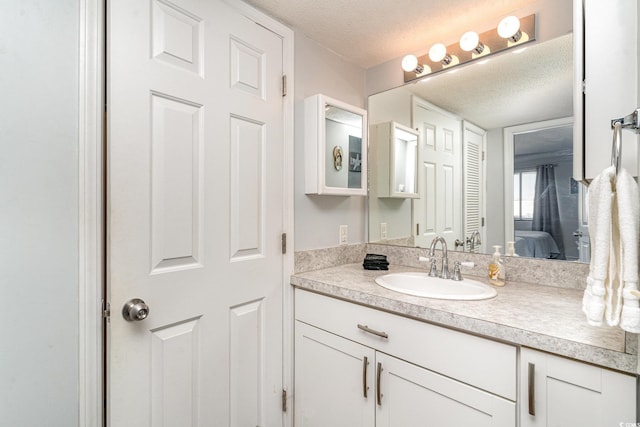 bathroom with vanity and a textured ceiling