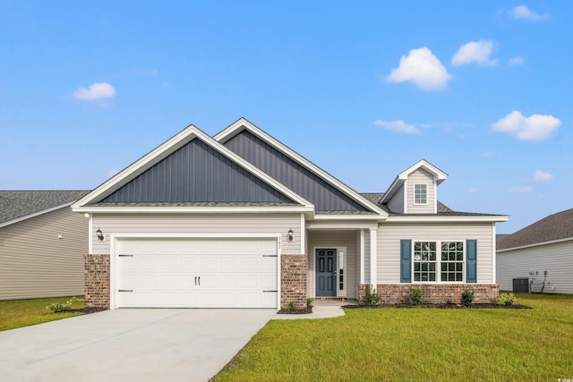 craftsman inspired home with cooling unit, a garage, and a front lawn