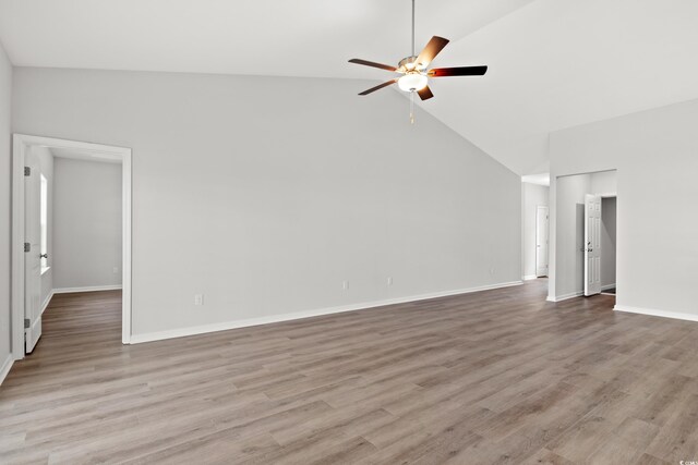 unfurnished living room featuring high vaulted ceiling, light hardwood / wood-style flooring, and ceiling fan