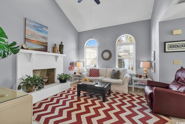 living room featuring ceiling fan, high vaulted ceiling, and a brick fireplace