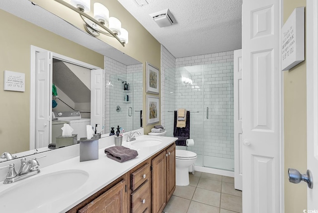 bathroom with tile patterned floors, a shower with door, a textured ceiling, and toilet