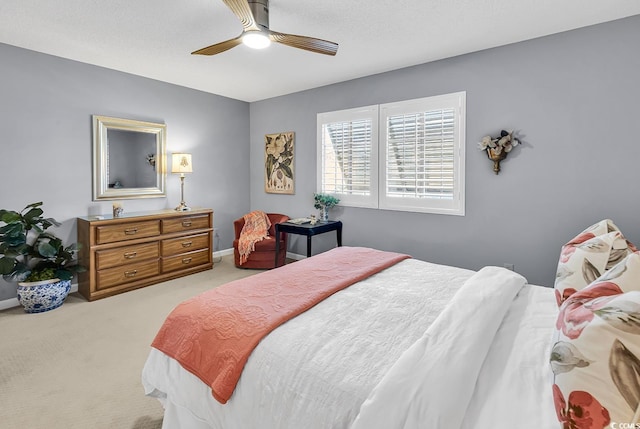 bedroom with ceiling fan and light colored carpet