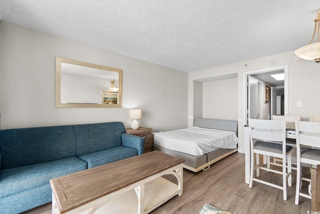 bedroom featuring hardwood / wood-style floors and a textured ceiling