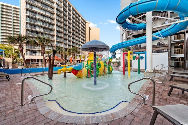 view of swimming pool with a playground