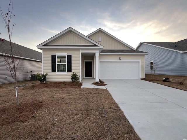 view of front of property featuring central AC unit and a garage