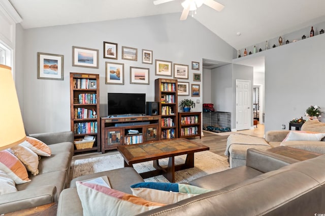 living room featuring a fireplace, wood-type flooring, vaulted ceiling, and ceiling fan