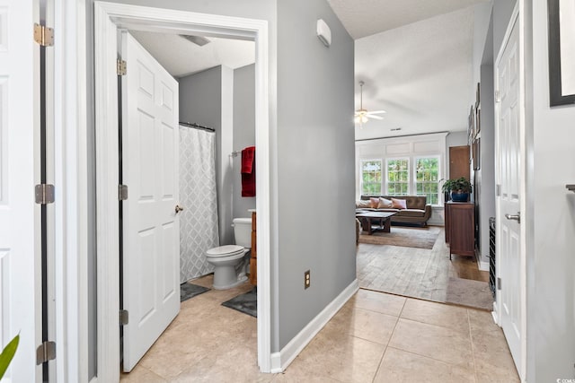 bathroom featuring tile patterned floors, ceiling fan, toilet, and a textured ceiling