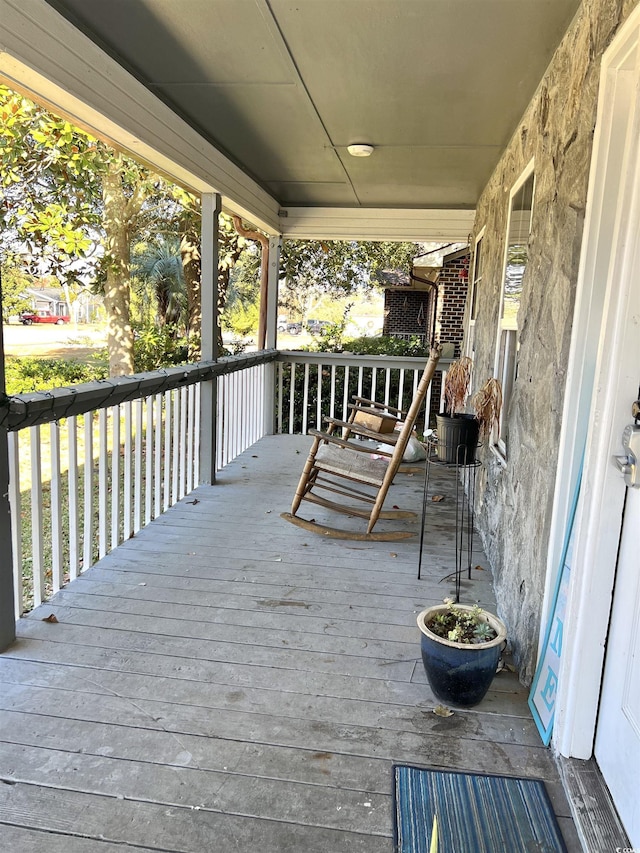 wooden terrace featuring covered porch