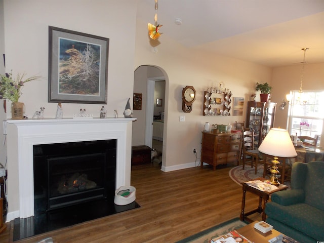 living room with a notable chandelier and hardwood / wood-style floors