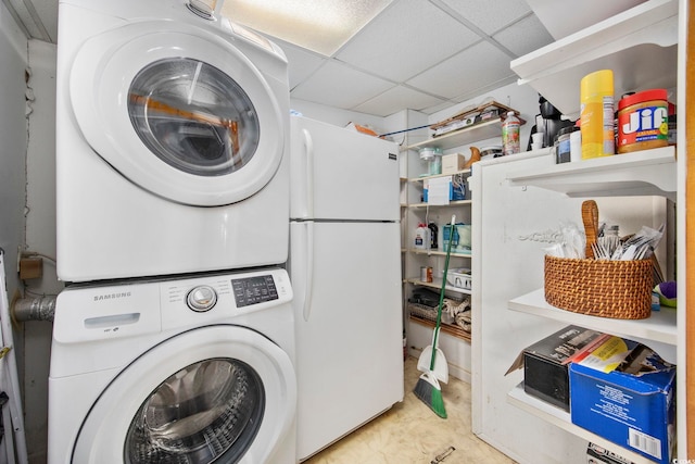 clothes washing area featuring stacked washing maching and dryer