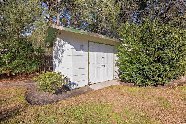 view of outdoor structure featuring a lawn