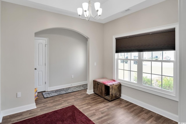 interior space with hardwood / wood-style floors and a notable chandelier