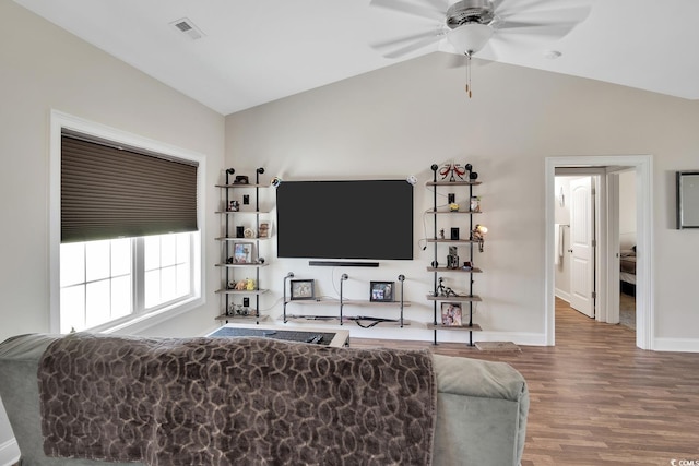 living room with hardwood / wood-style floors, ceiling fan, and vaulted ceiling