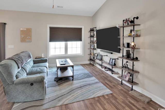 living room with hardwood / wood-style flooring and lofted ceiling