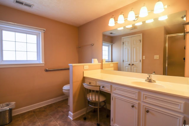 bathroom with tile patterned floors, vanity, toilet, and an enclosed shower