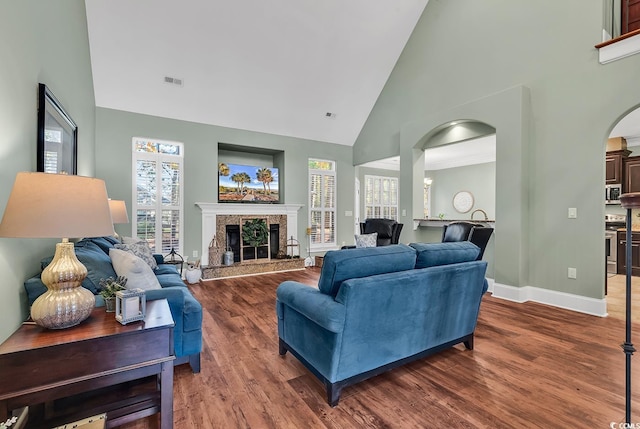 living room featuring dark hardwood / wood-style floors and high vaulted ceiling