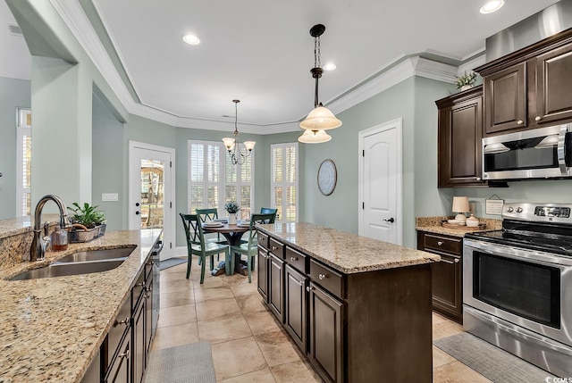 kitchen with appliances with stainless steel finishes, dark brown cabinetry, crown molding, sink, and decorative light fixtures