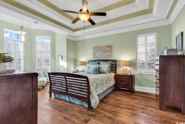 bedroom featuring ornamental molding, multiple windows, dark wood-type flooring, and ceiling fan