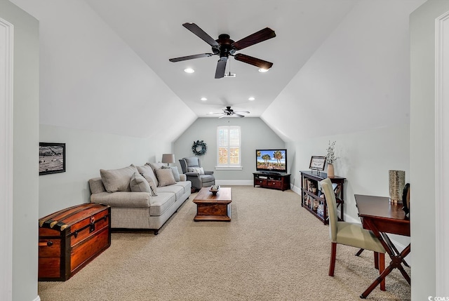 carpeted living room with ceiling fan and vaulted ceiling