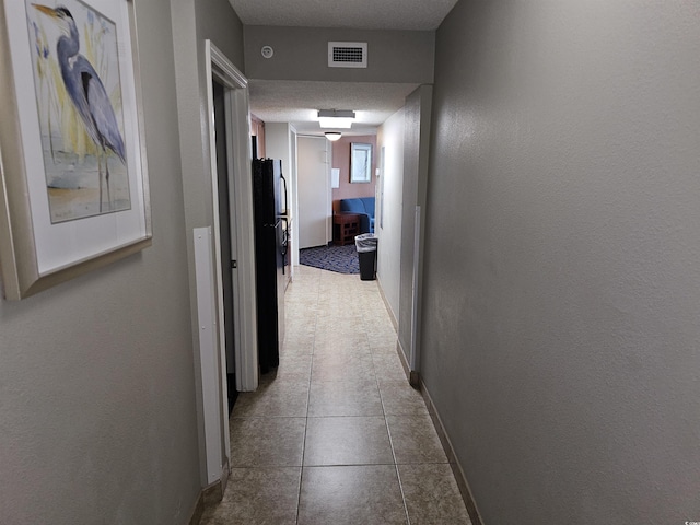 corridor with a textured ceiling