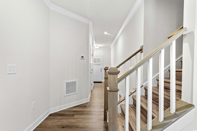 stairs featuring hardwood / wood-style floors and crown molding