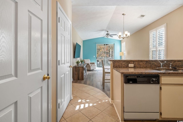 kitchen featuring dishwasher, lofted ceiling, sink, hanging light fixtures, and light tile patterned floors