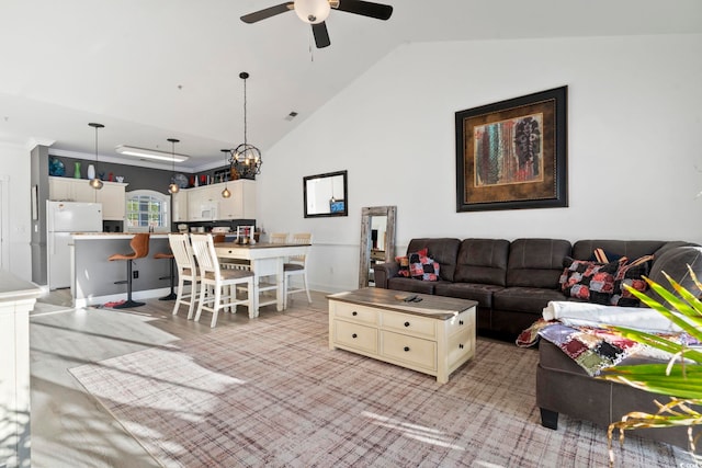 living room with ceiling fan, crown molding, and vaulted ceiling