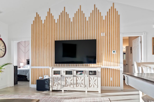 living room featuring light hardwood / wood-style flooring and high vaulted ceiling