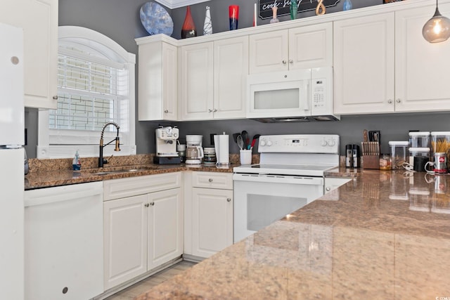 kitchen featuring pendant lighting, white appliances, white cabinetry, and sink