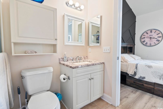 bathroom featuring vanity, hardwood / wood-style flooring, and toilet