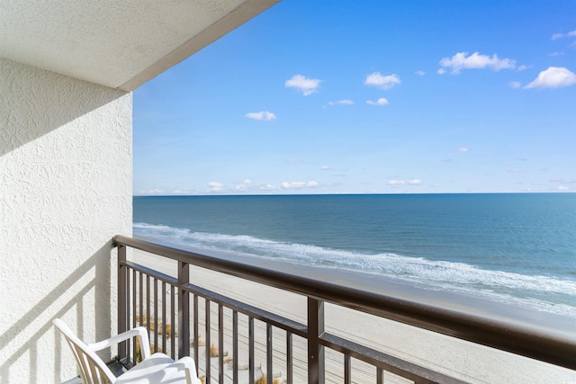 balcony with a view of the beach and a water view