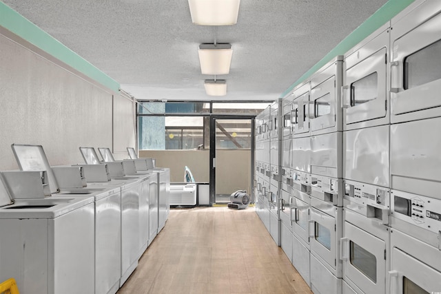 laundry area featuring a textured ceiling, separate washer and dryer, and stacked washer and clothes dryer