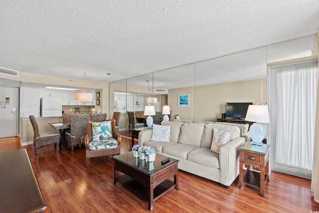 9820 Queensway Blvd Unit 903, Myrtle Beach, SC 29572 - living room with wood finished floors and a textured ceiling