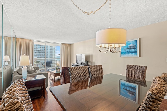 dining space featuring a textured ceiling, dark hardwood / wood-style floors, and floor to ceiling windows