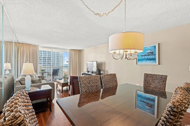 9820 Queensway Blvd Unit 903, Myrtle Beach, SC 29572 - dining space featuring a textured ceiling, dark wood-style flooring, expansive windows, and a chandelier